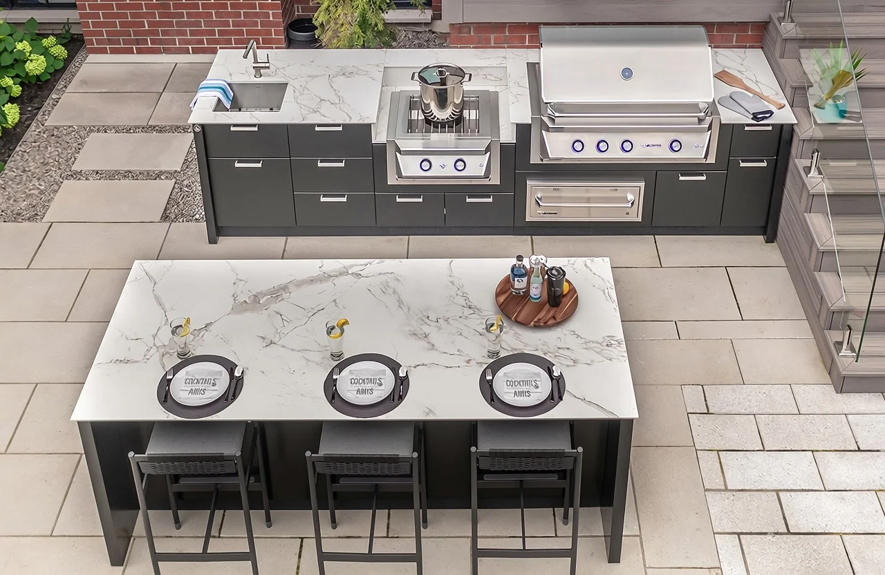 Luxury outdoor kitchen setup in a Toronto backyard with built-in grill and stainless steel cabinets