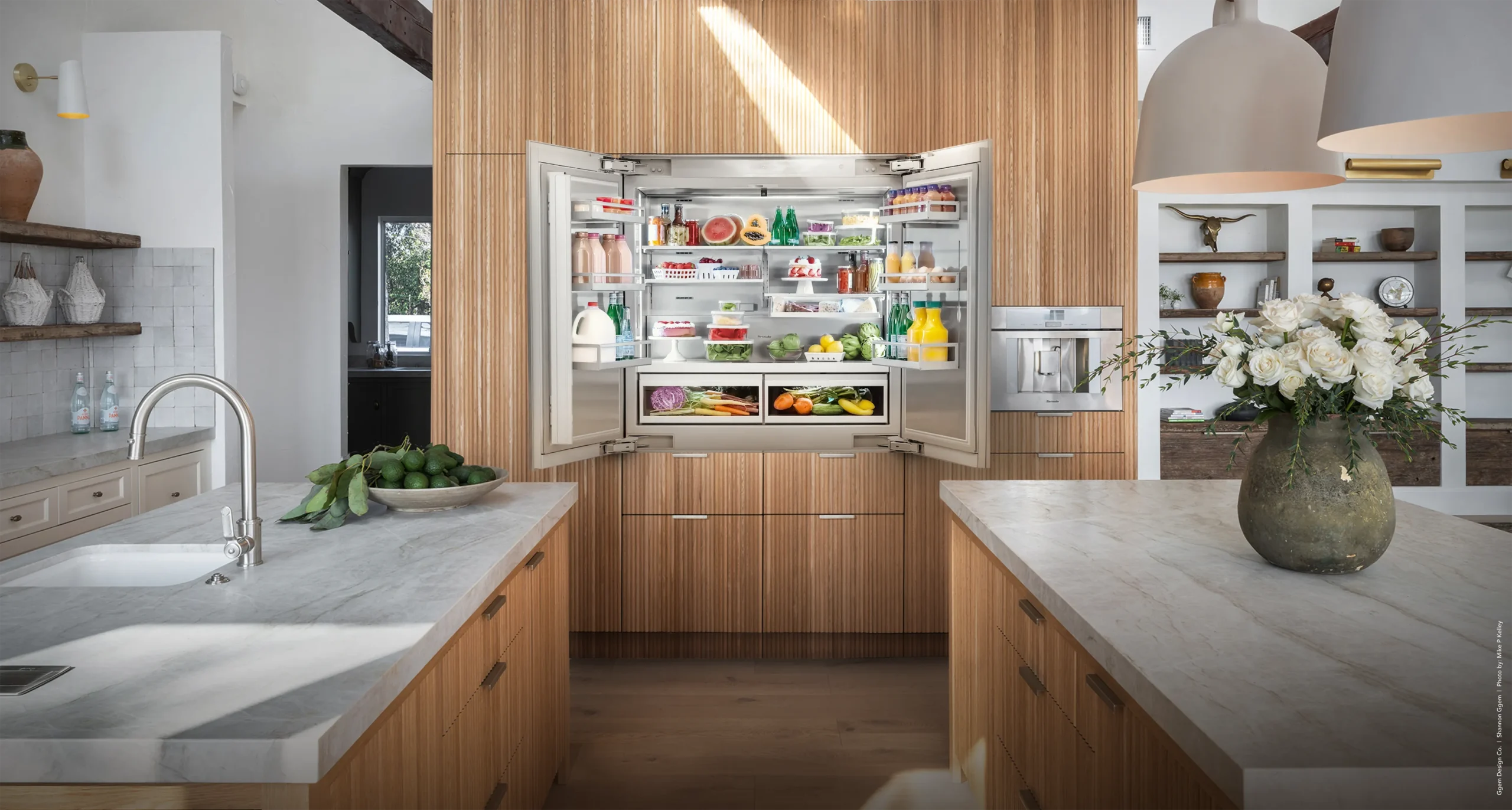 Thermador built-in refrigerator in a light oak kitchen